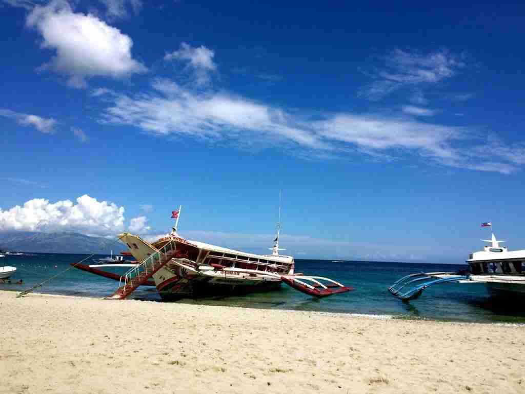 Ferries waiting to row at White Beach, Puerto Galera, Philippines