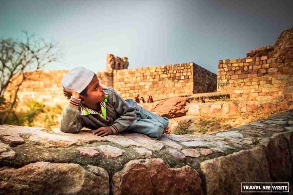 A kid resting inside the Tughlaqabad Fort, Delhi, India