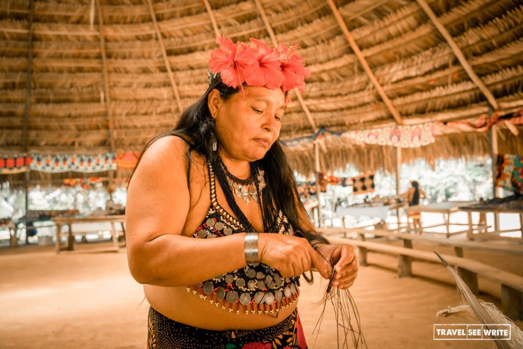 Erito Barrigón's wife shows us how Embera people make handicrafts using natural products.